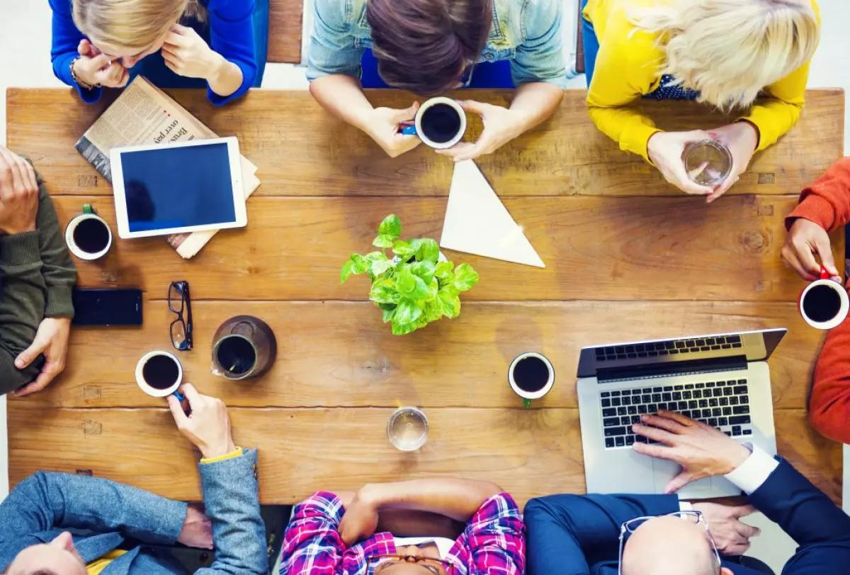 A sphere of influence in real estate group sitting around a table