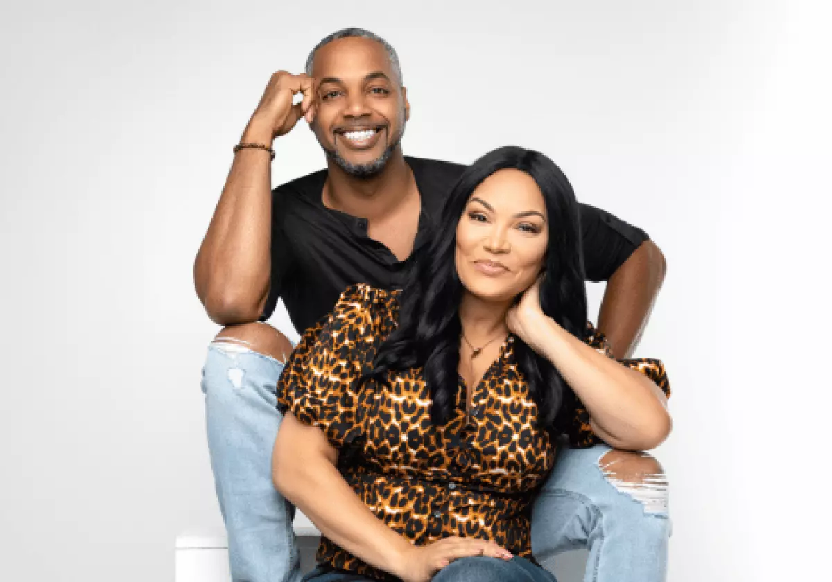 Mike Jackson wearing black t-shirt and ripped light blue jeans and wife, Egypt Sherrod wearing short sleeved leopard print top