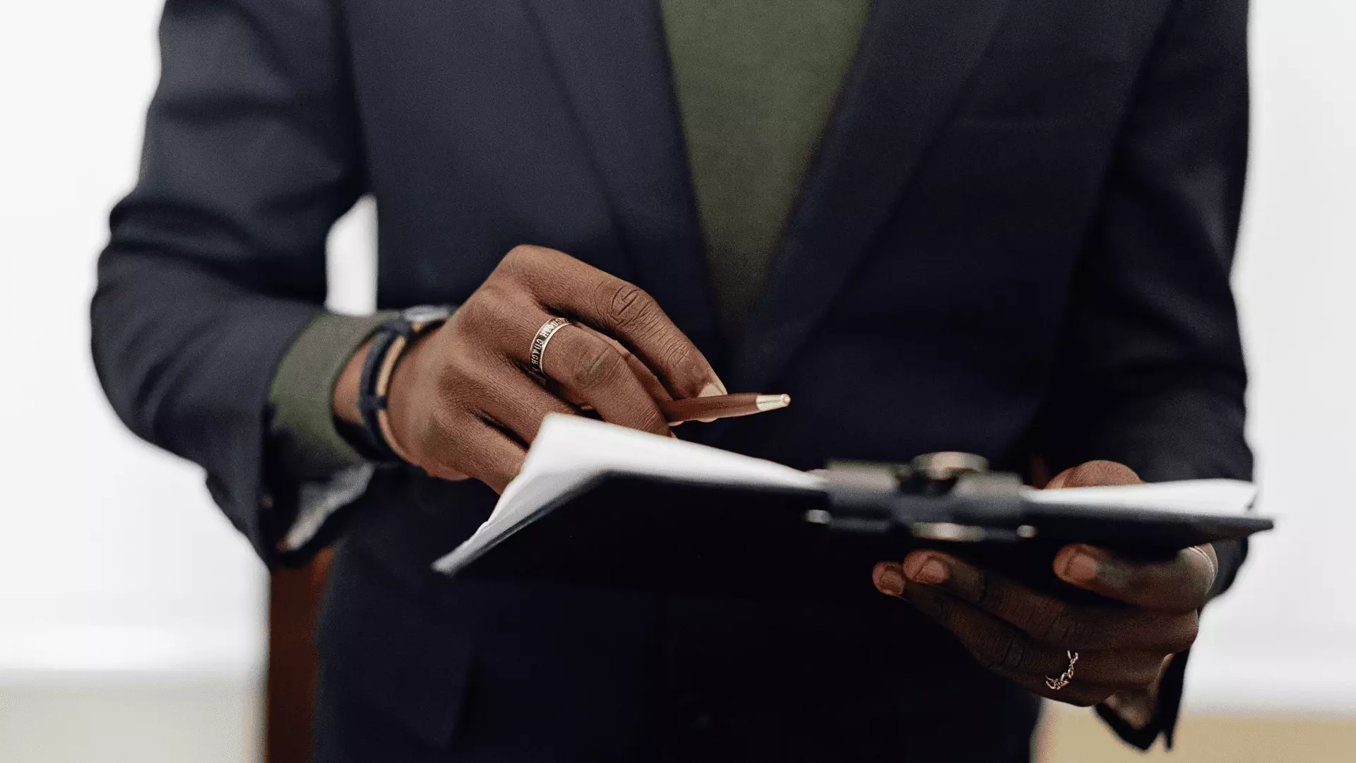 Real estate agent holding a clipboard with a pen in his hand