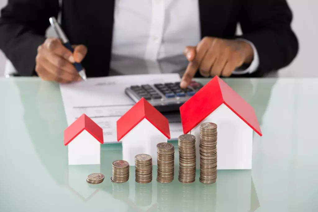 A man sitting at a desk working on real estate math