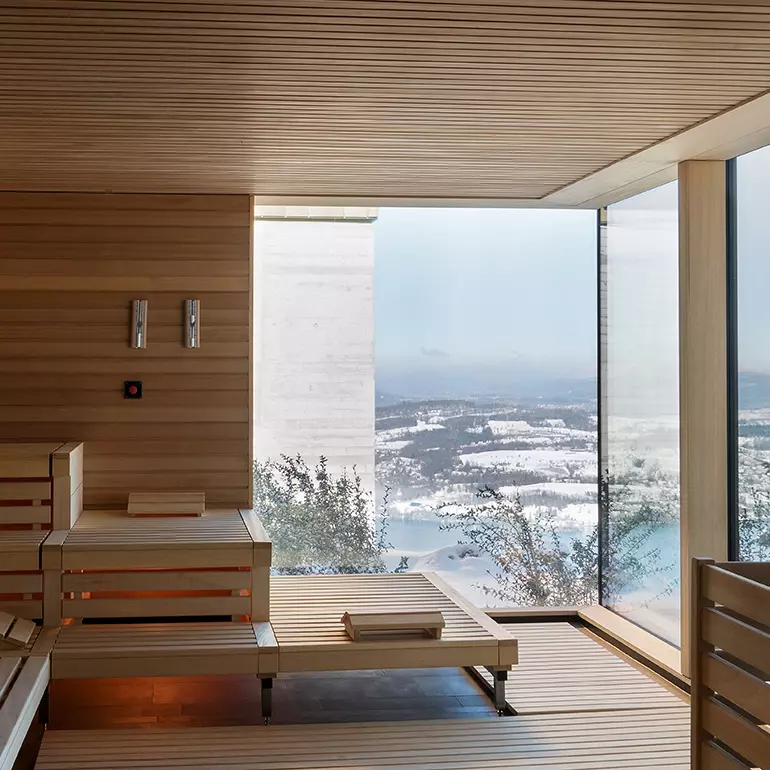 The architecture and design of this spa includes tile walls that meld with natural wood accents