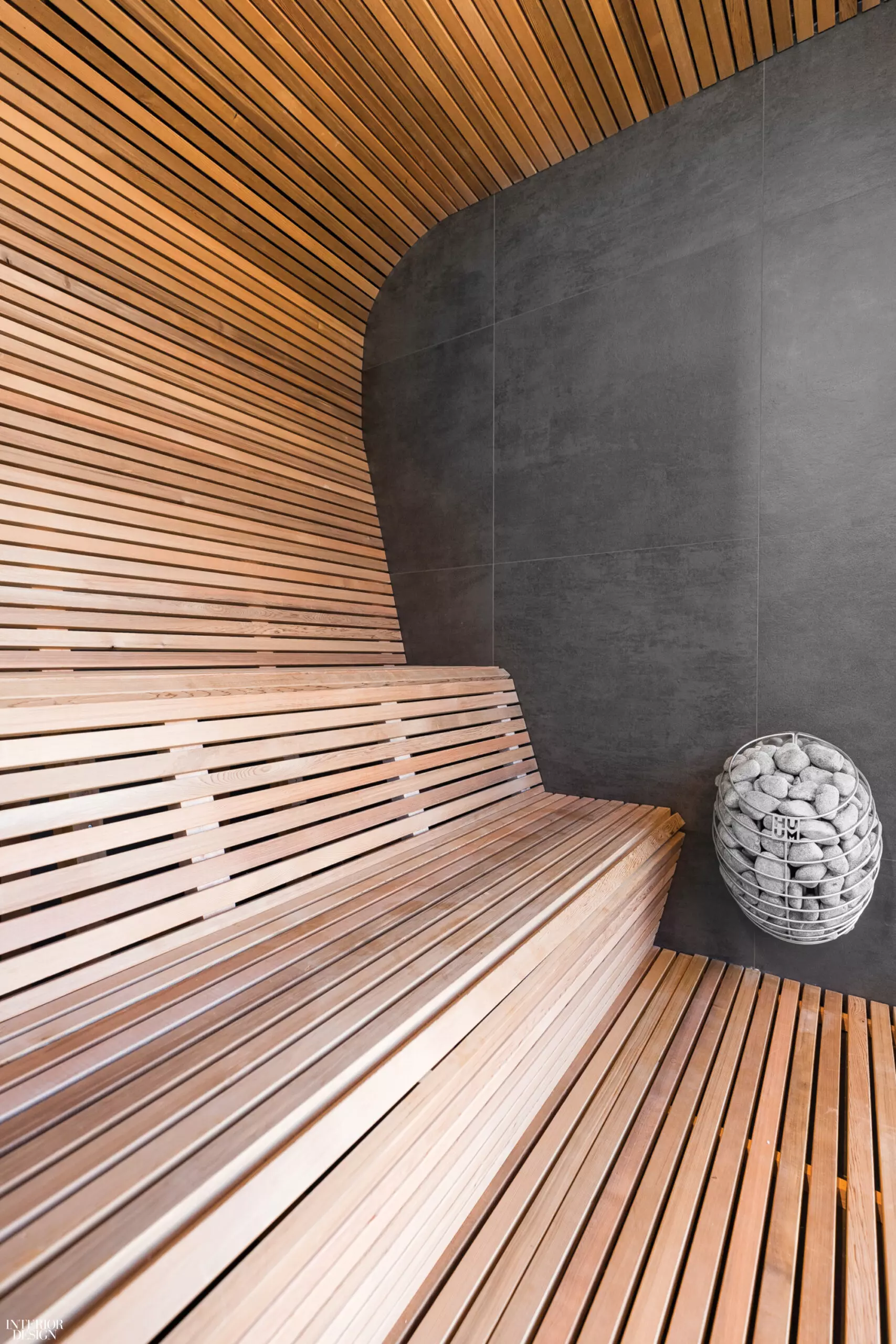 Wooden slats snake around the wall providing space to sit in this spa design