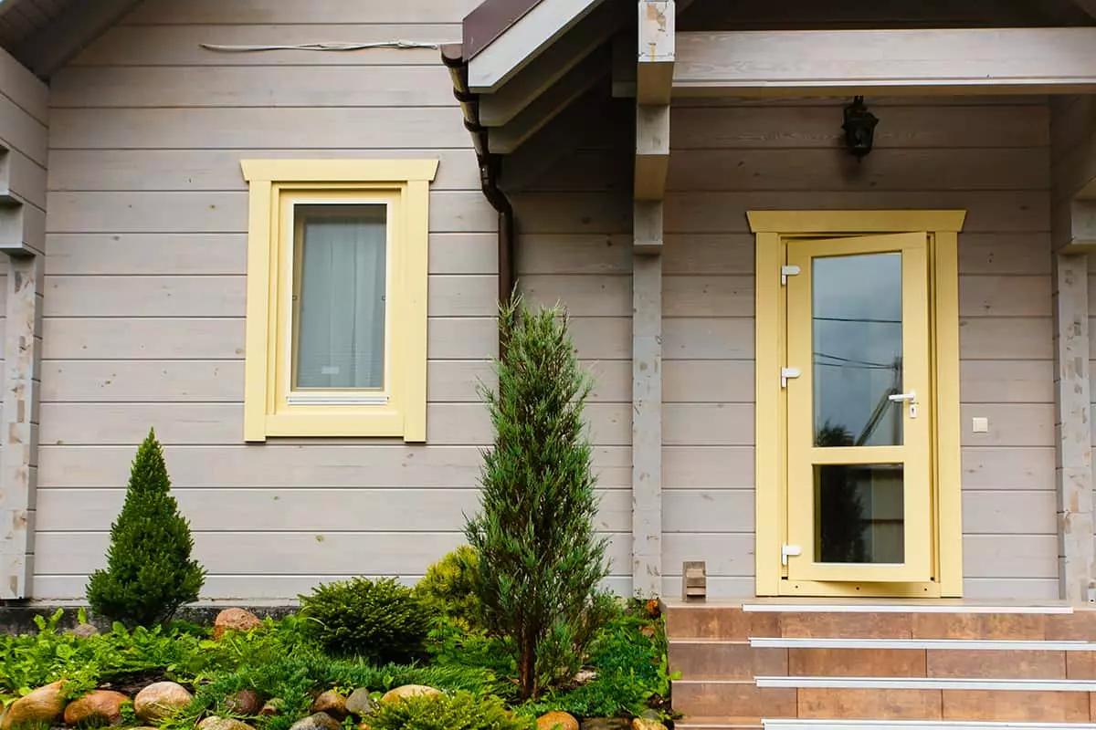 Bright Yellow Front Door on Gray Siding