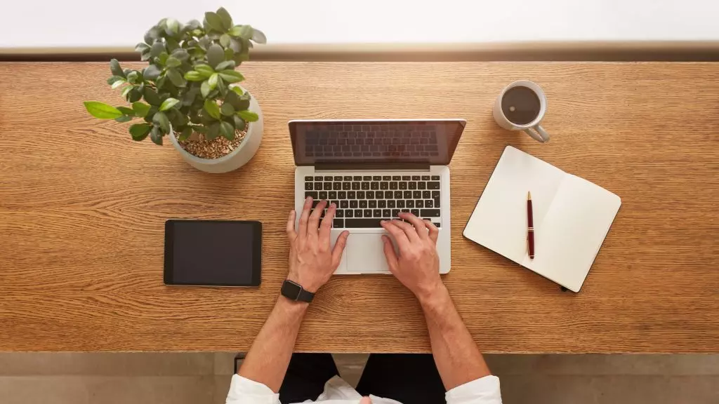 Someone working on a laptop on a desk