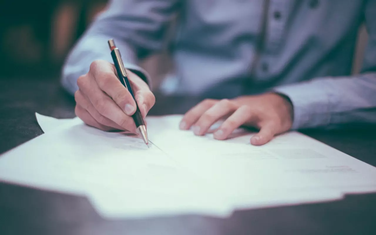 A man signing a loan agreement