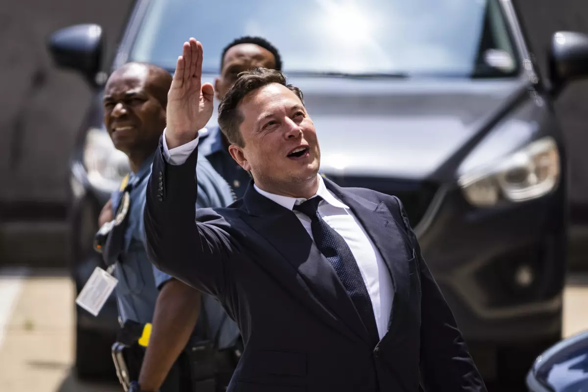 Elon Musk, chief executive officer of Tesla Inc., waves while departing court during the SolarCity trial in Wilmington, Delaware, U.S., on Tuesday, July 13, 2021