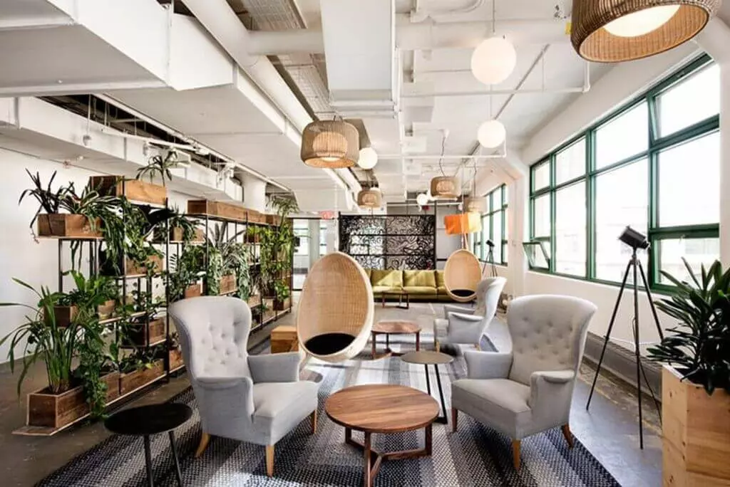 A green wall in an office with a table and chairs