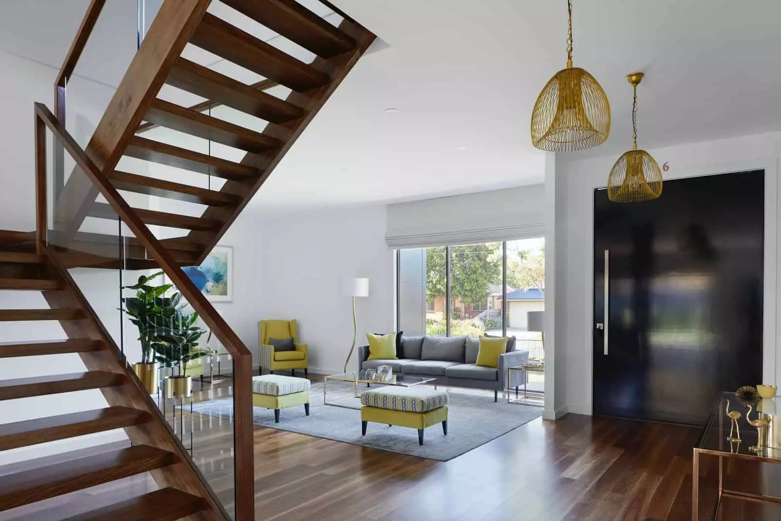 Brown wooden spiral staircase near gray couch modern interior design