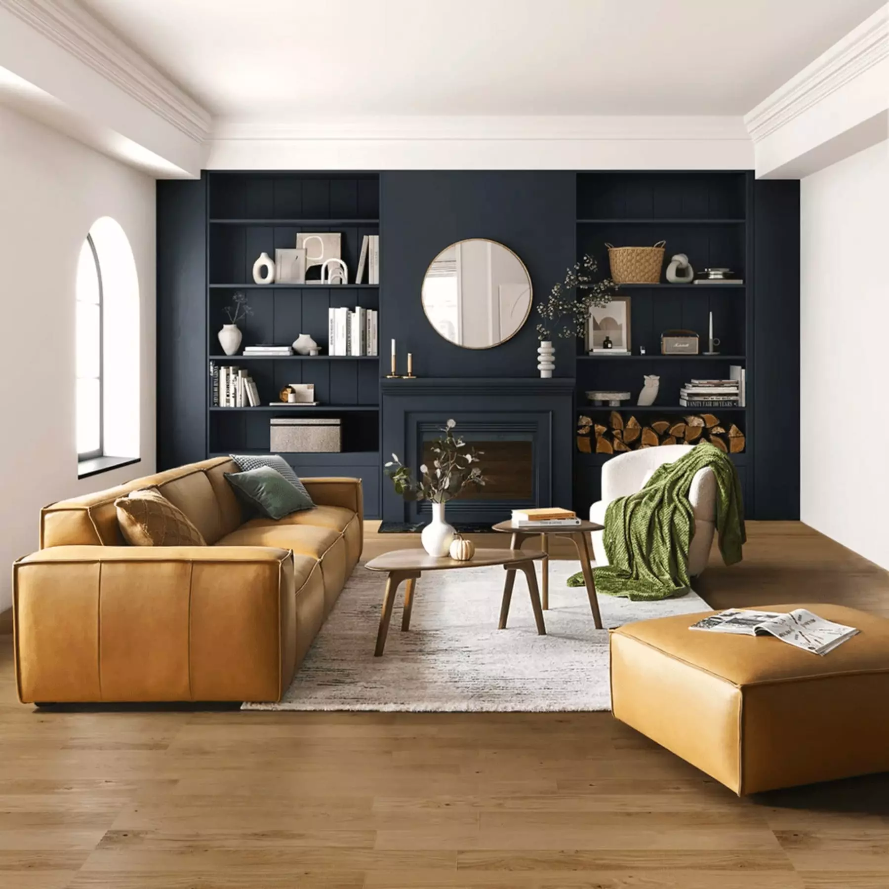 A leather extended sofa against a navy accent wall.