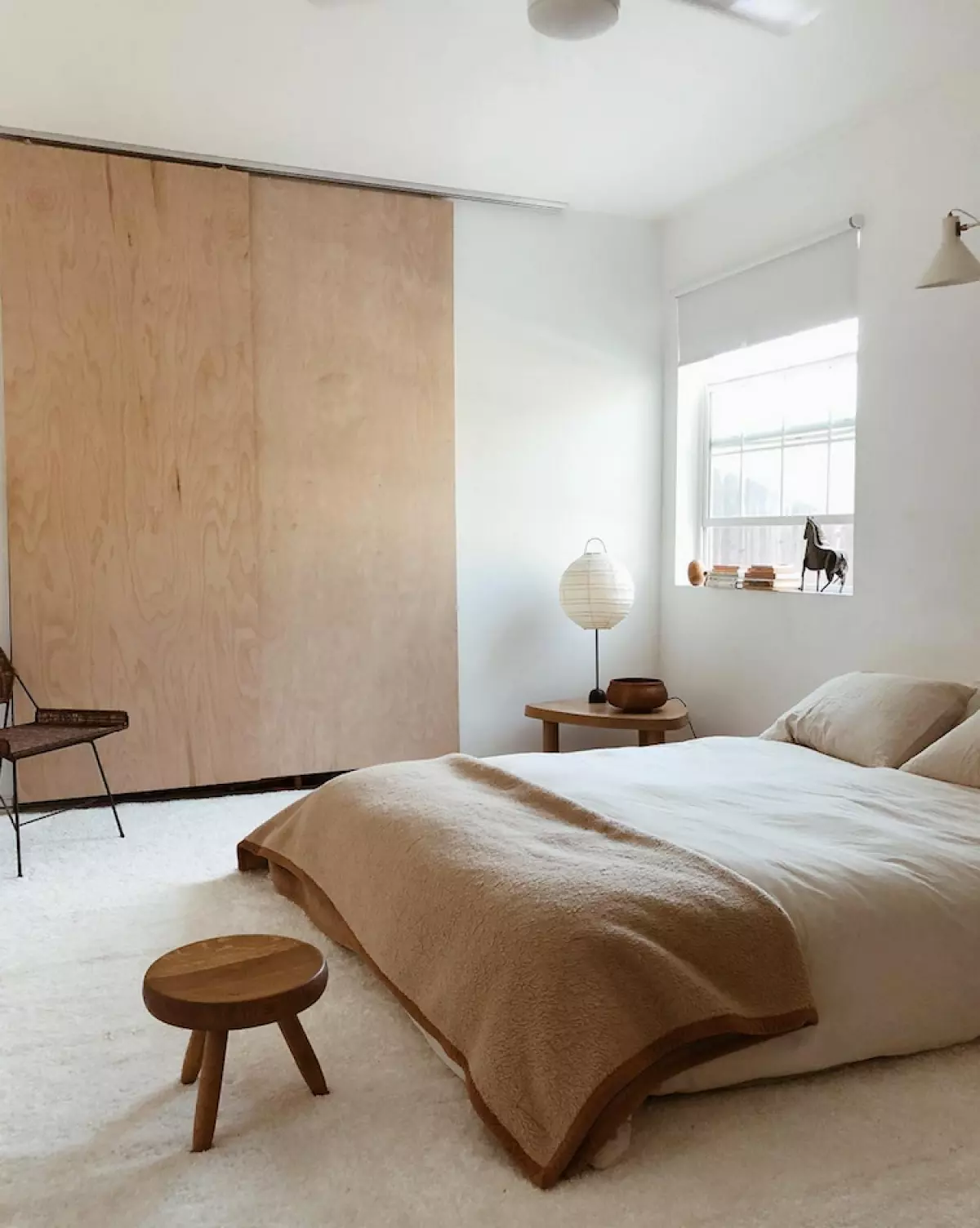 Image of Japandi bedroom with plywood closet doors and light-colored bedding