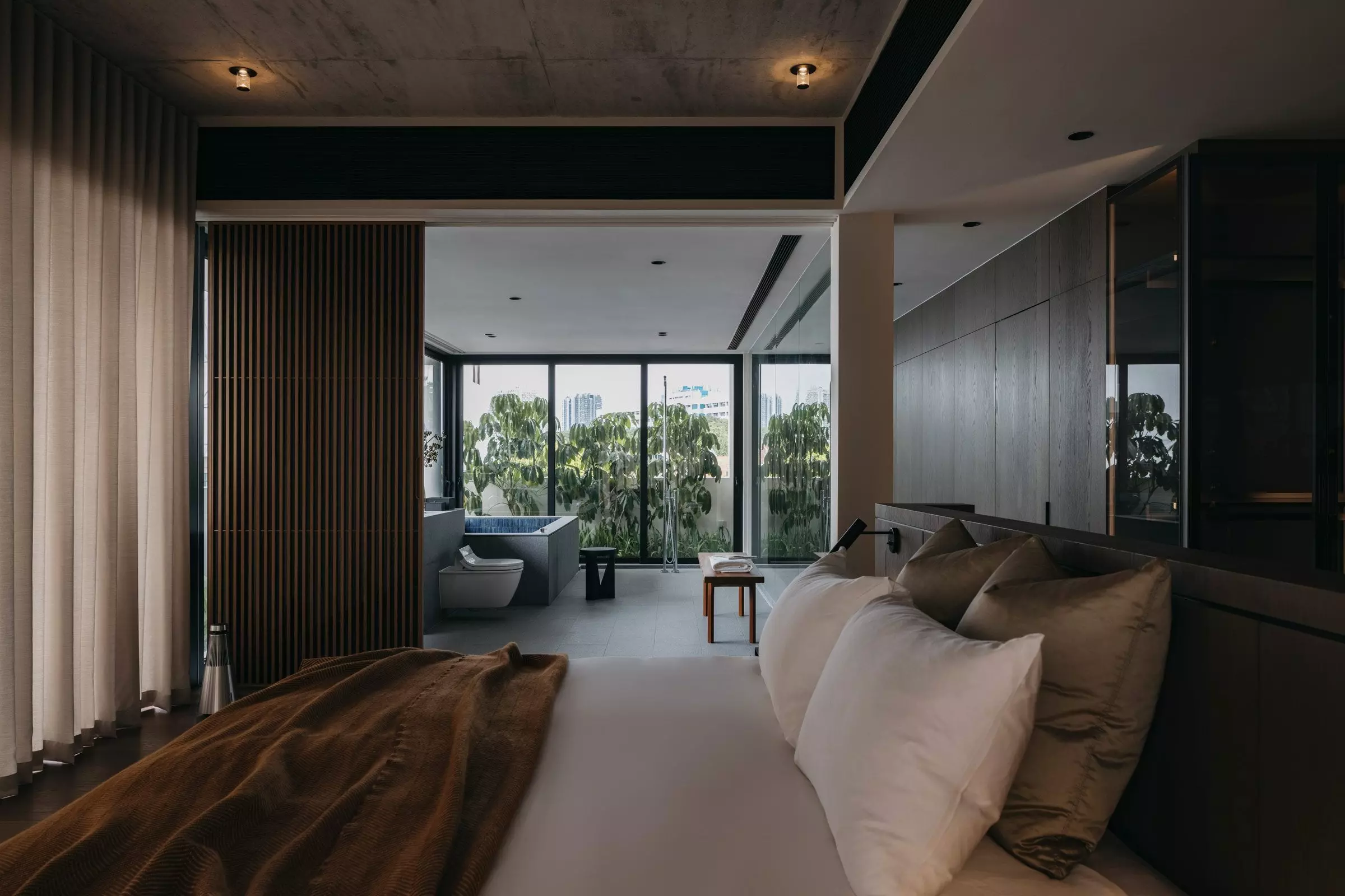 Image of a moody Japanese bedroom design with a vertical wood slat room divider