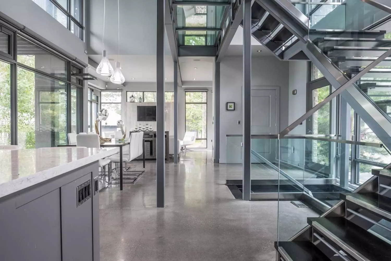 Ultra-modern glass and metal staircase design. Concrete floors. Industrial design.