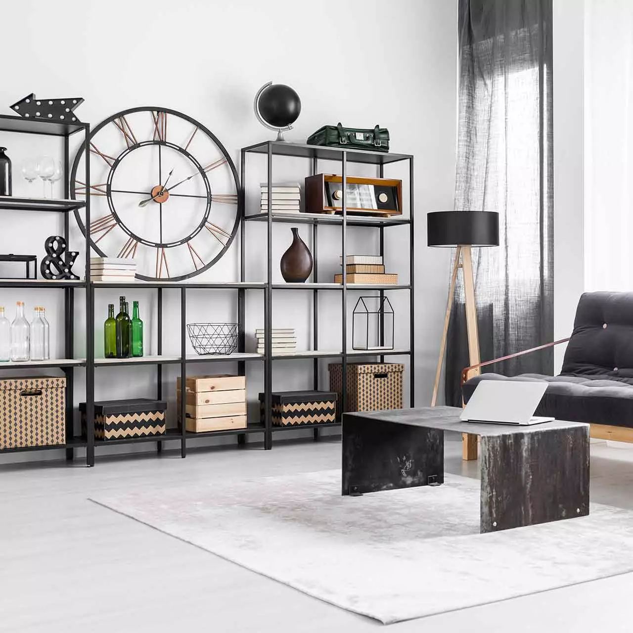 Industrial style living room design with white typographic prints, factory window meets shaggy rugs, iron piping, and wooden floors