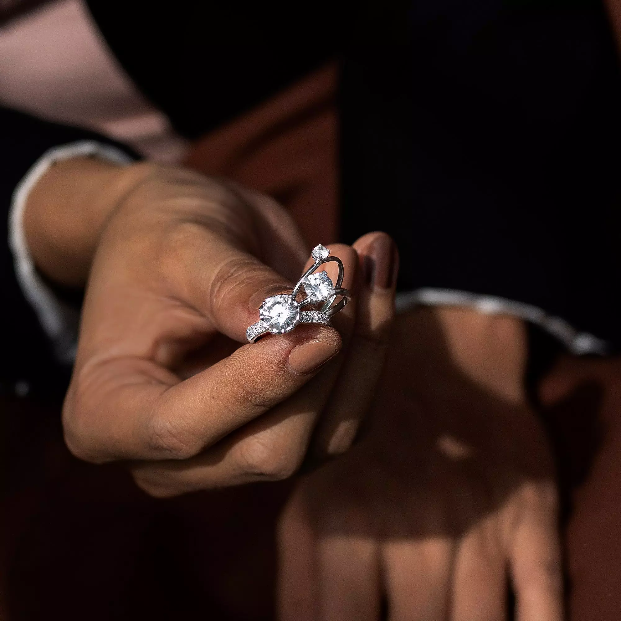 Wearing rings on specific fingers.