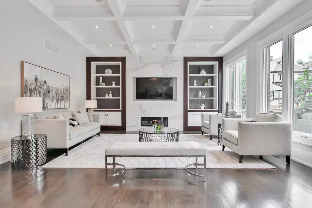 A dining room with a modern table and full back wall of floor-to-ceiling windows