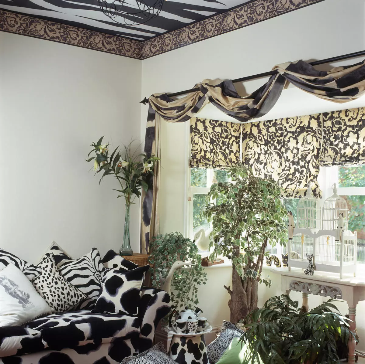 Black+white animal print sofa and cushions in nineties living room