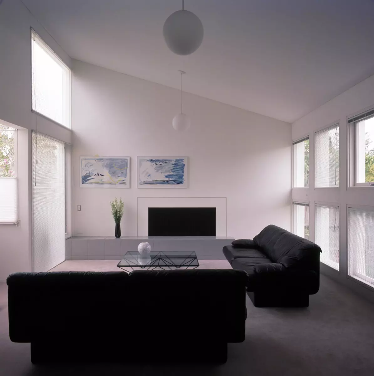 Black sofas in a minimalist style white living room