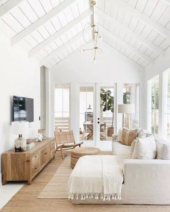 Love this beautiful modern living room design with a sectional, vaulted ceilings, and neutral furniture and decor