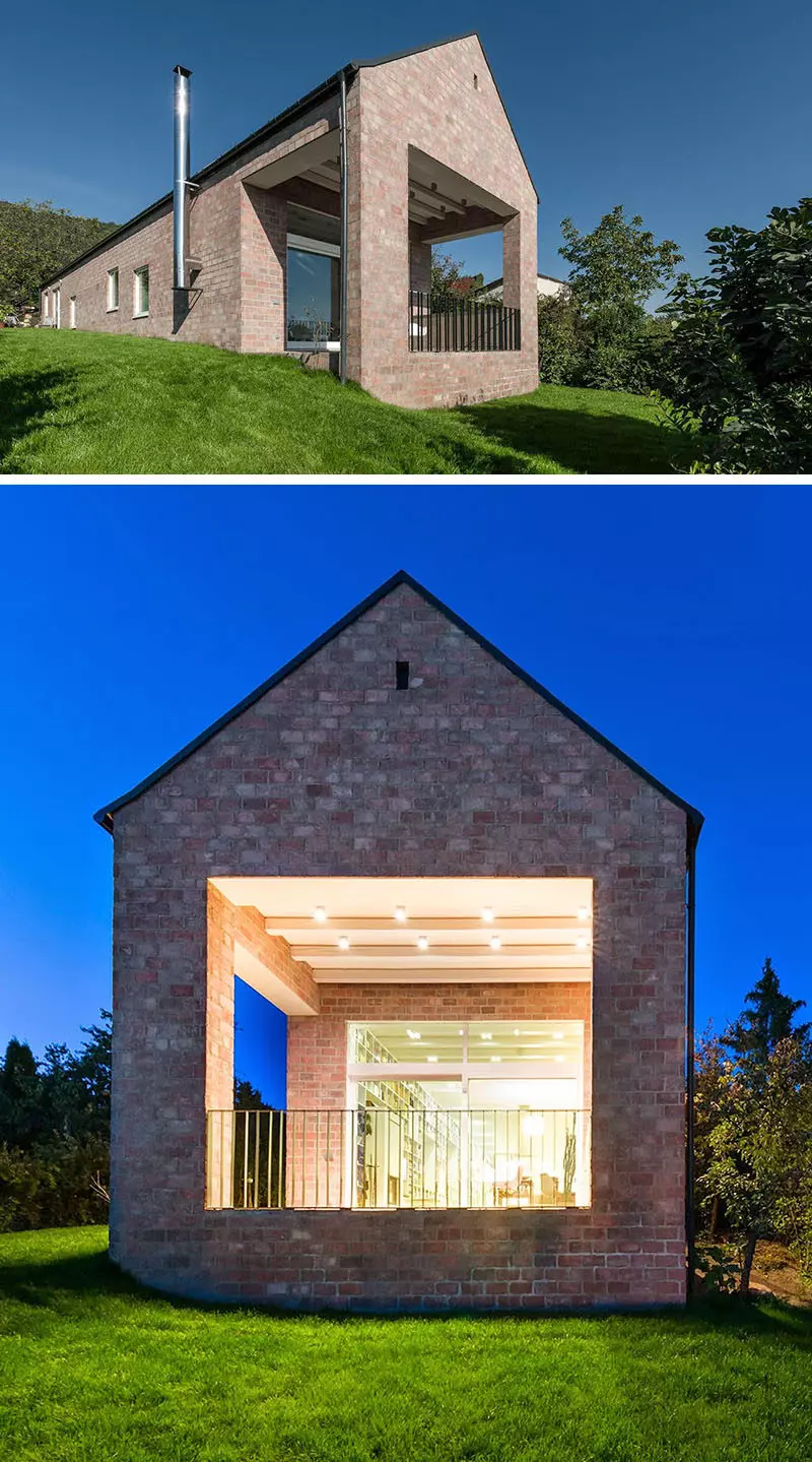 White bricks cover much of the exterior of this home and contrast the dark cedar siding and metal trim.