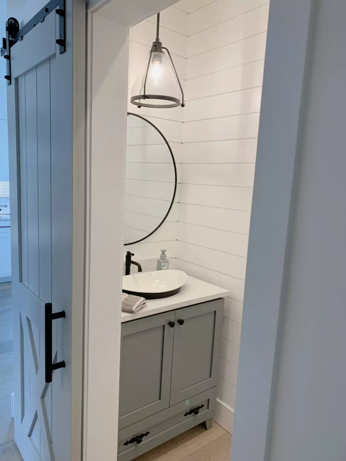 Sherwin Williams High Reflective White, small bathroom ideas with shiplap walls and gray vanity, round mirror. Client photo of Kylie M Interiors Edesign