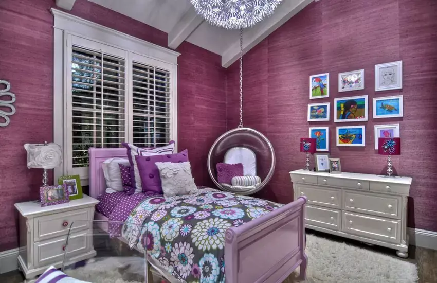 Bedroom with birds nest hanging wicker chair and outdoor views