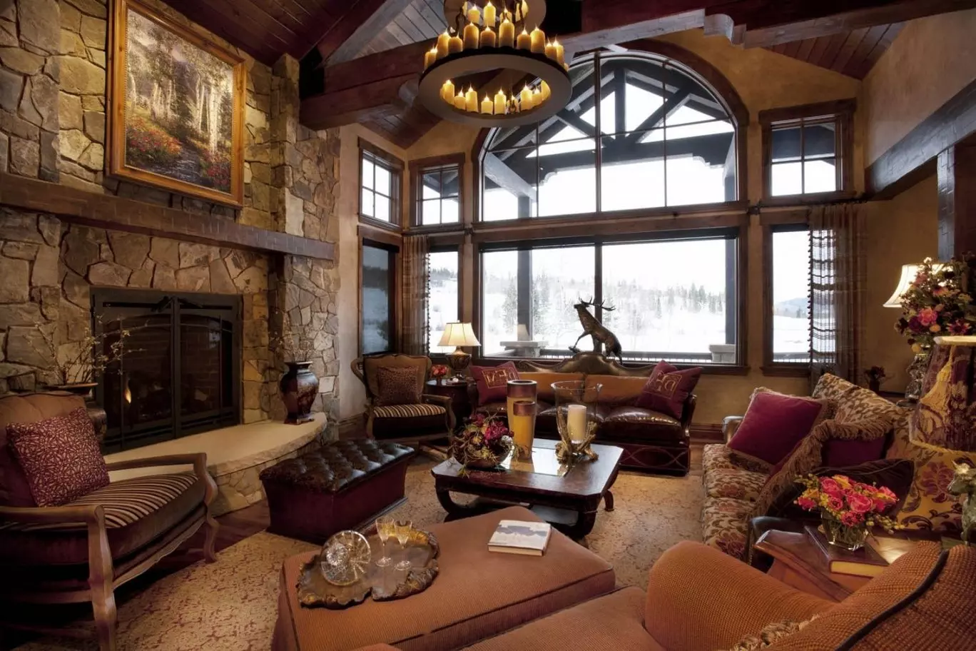 Chalet-styled house interior with huge windows and candlesticks in the medieval chandelier