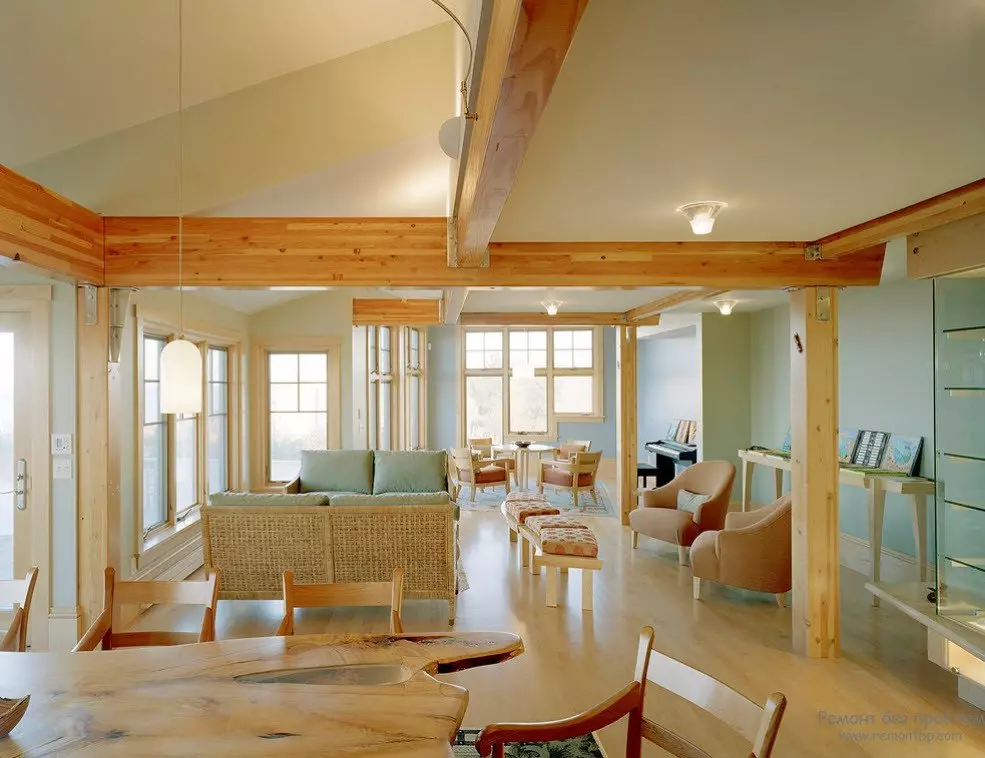 Painted white open layout interior of a private house with a large wooden coffee table