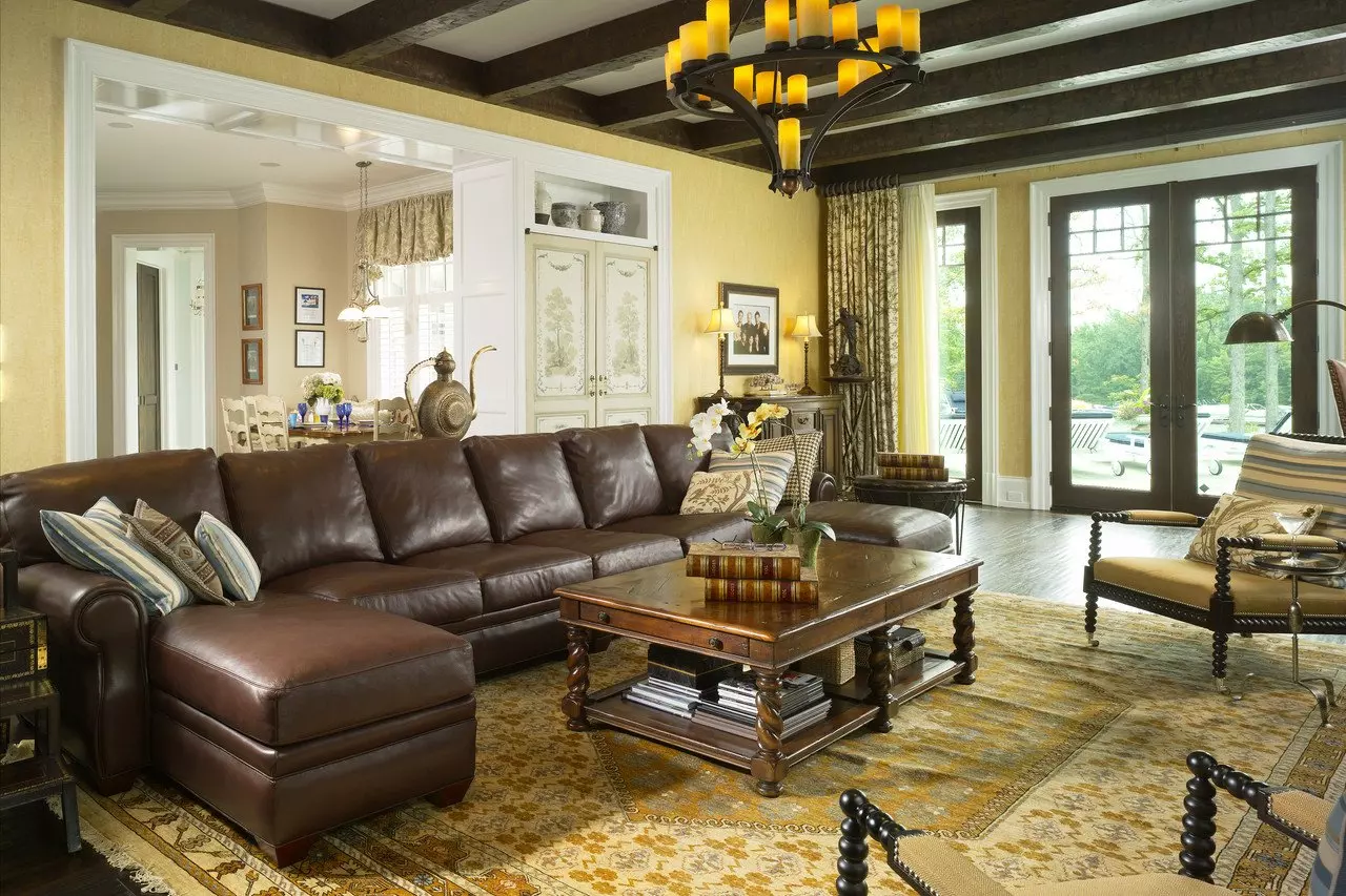 Chocolate brown leather sofa and noble lacquered table along with a dark wooden ceiling for the German-styled interior