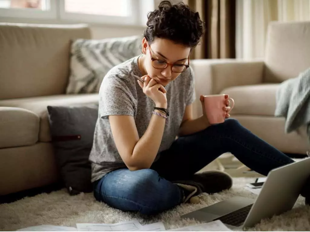 Young woman studying for real estate exam in her living room