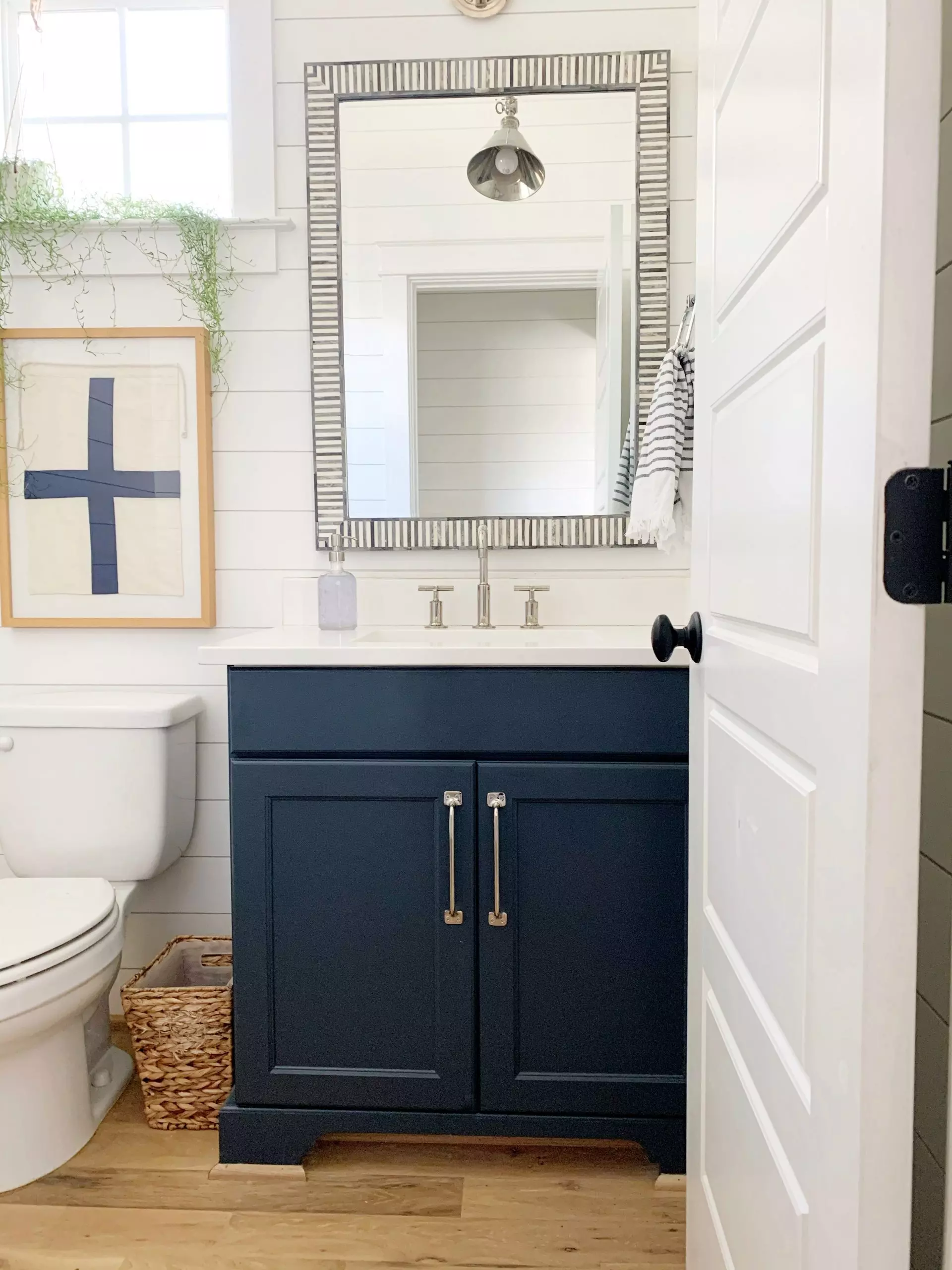 navy painted bathroom cabinets in a white bathroom