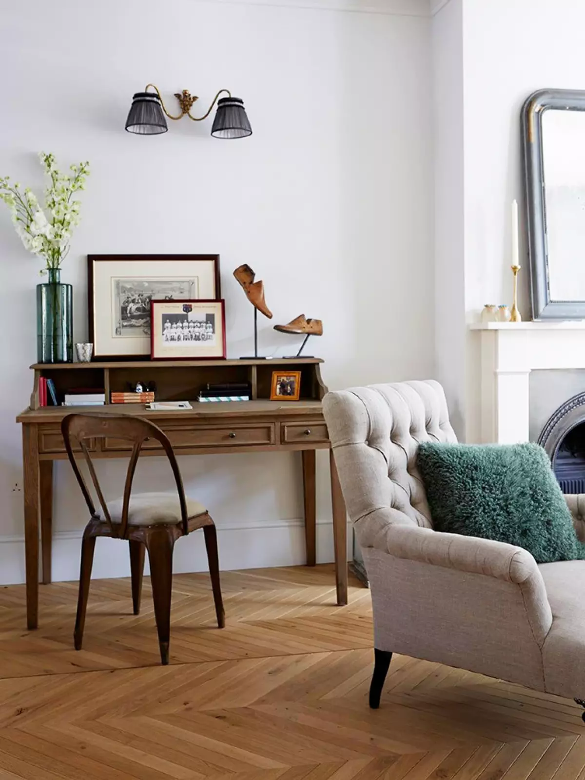 Classic wood roll top desk with metal desk chair and tufted gray armchair