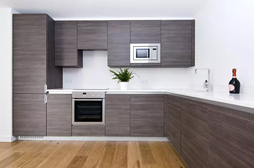 Floating shelves on tiled kitchen wall with countertops, and windows