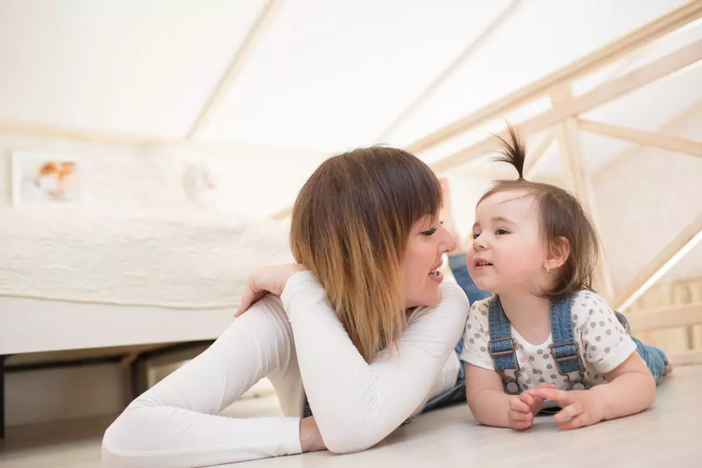 Young girl on toddler floor bed