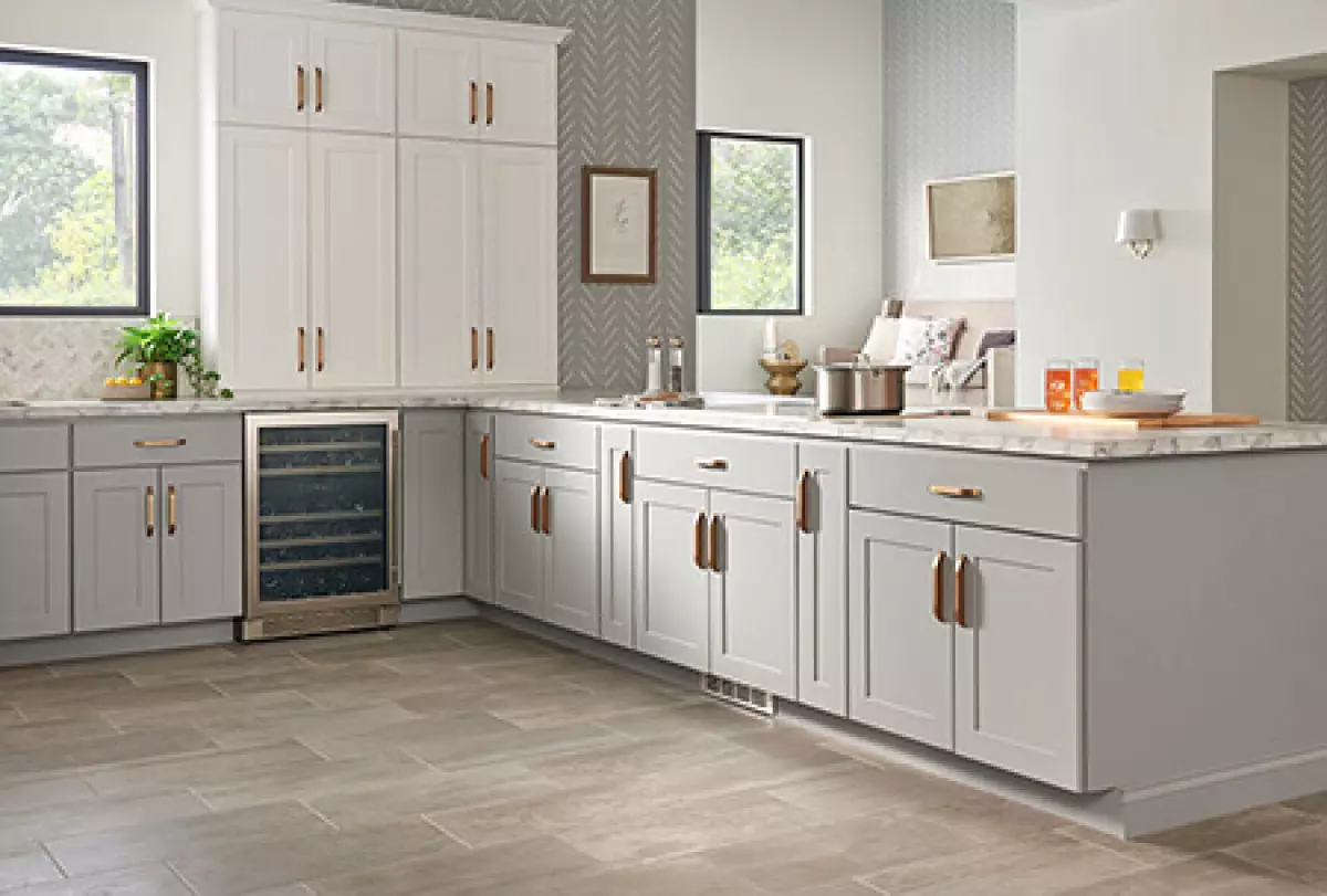 Light gray kitchen cabinets in bright, traditional kitchen.