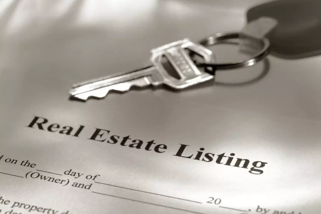 A real estate listing contract with a key