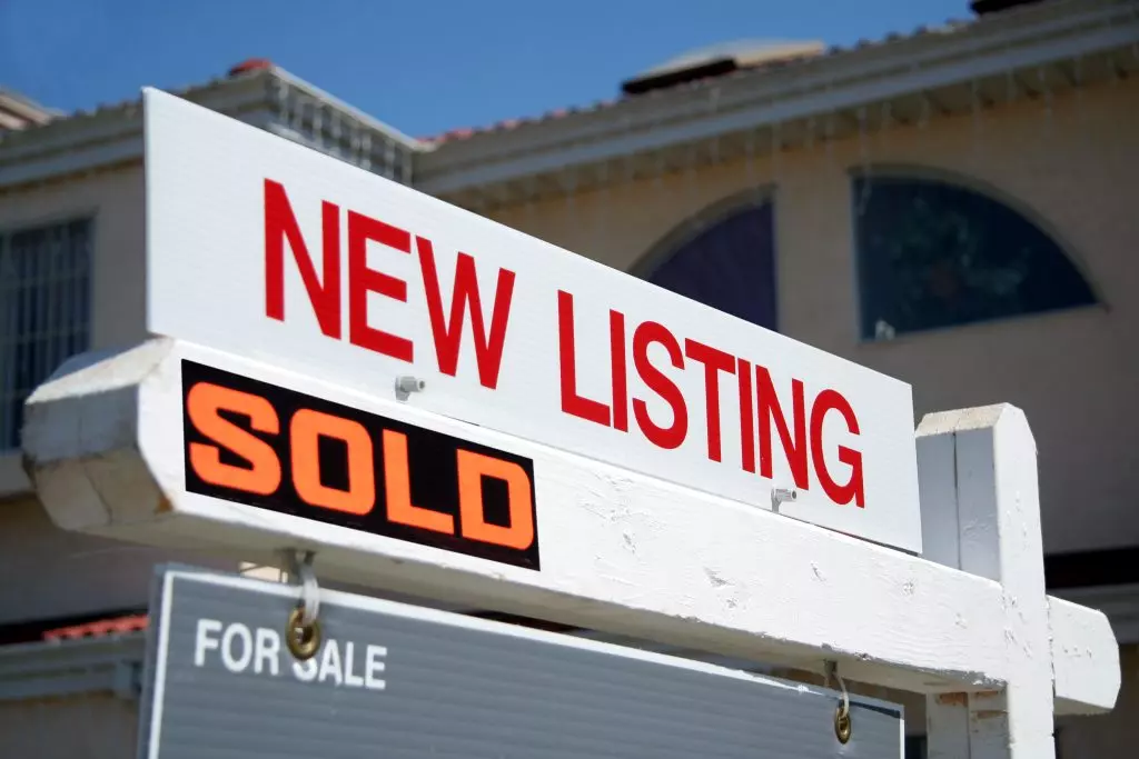 A sign that says "new listing" with a sold sign rider. If you