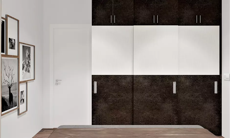 Simple 3 door wardrobe design in a dark brown and white color combination lends a cozy vibe to the bedroom.