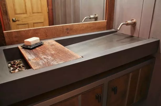 a white contemporary double-sink with colorful rocks in it