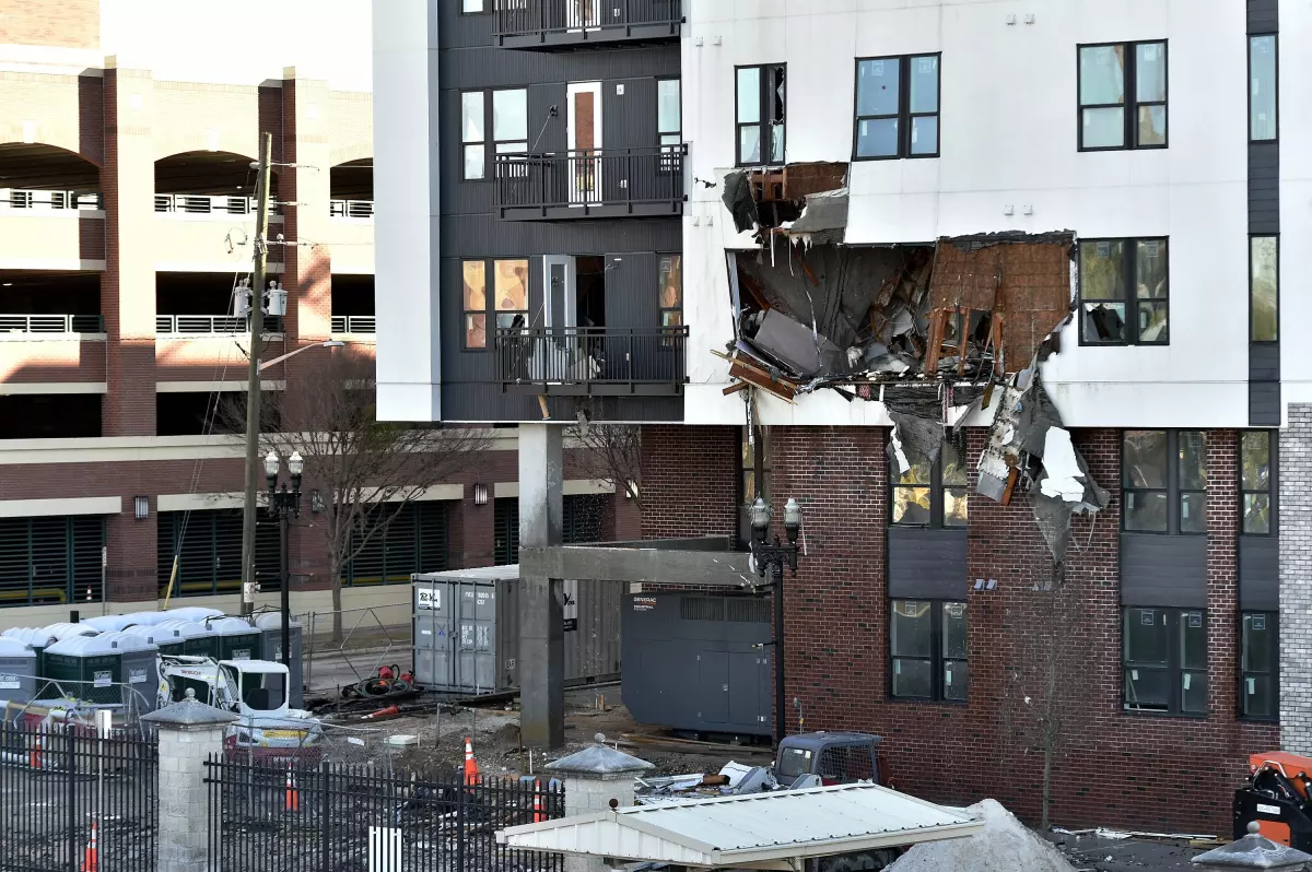 Sections of the west side of the RISE Doro apartment building are clearly damaged following Sunday and Monday