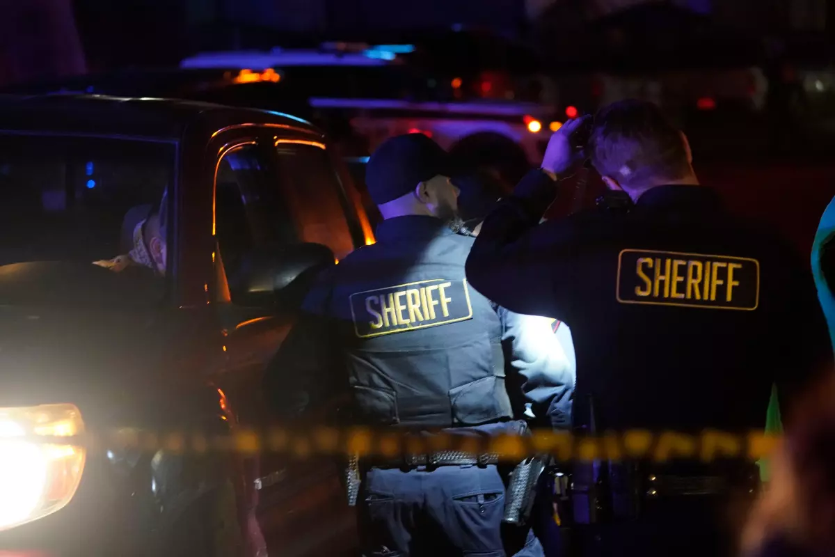 Law enforcement personnel on Monday are pictured patrolling the scene after a shooting in Half Moon Bay, California. Officials said seven people were killed in two related shootings Monday at a mushroom farm and a trucking firm in a coastal community south of San Francisco.