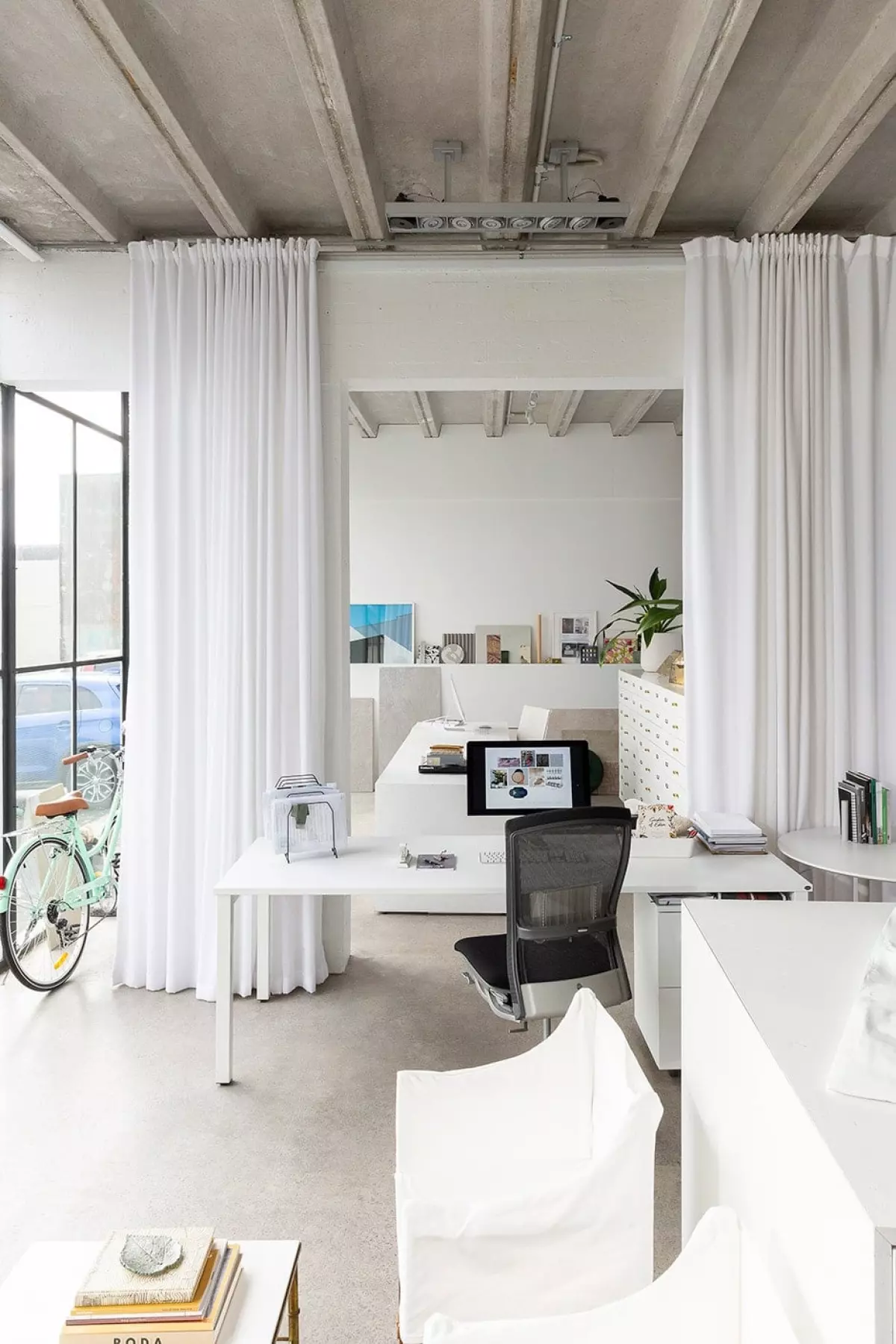 ABOVE This view into the drawing studio showcases the white palette and simple textures that provide a blank canvas for the JKW team’s work. A picture ledge at the rear of the room puts suppliers’ latest and greatest on display.