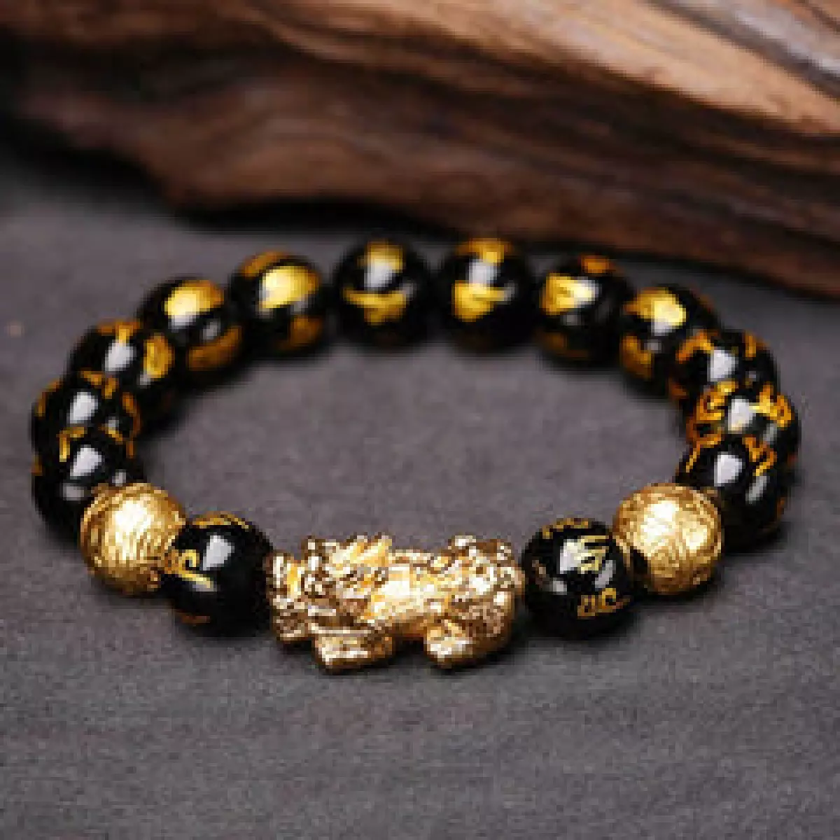 A sleek black obsidian bracelet featuring a powerful Pi Yao charm.