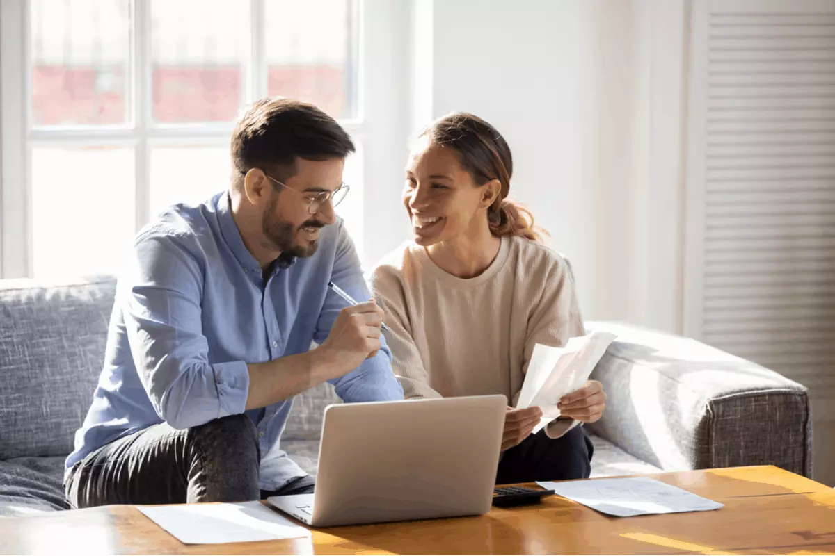 A couple reviewing finances at a computer.