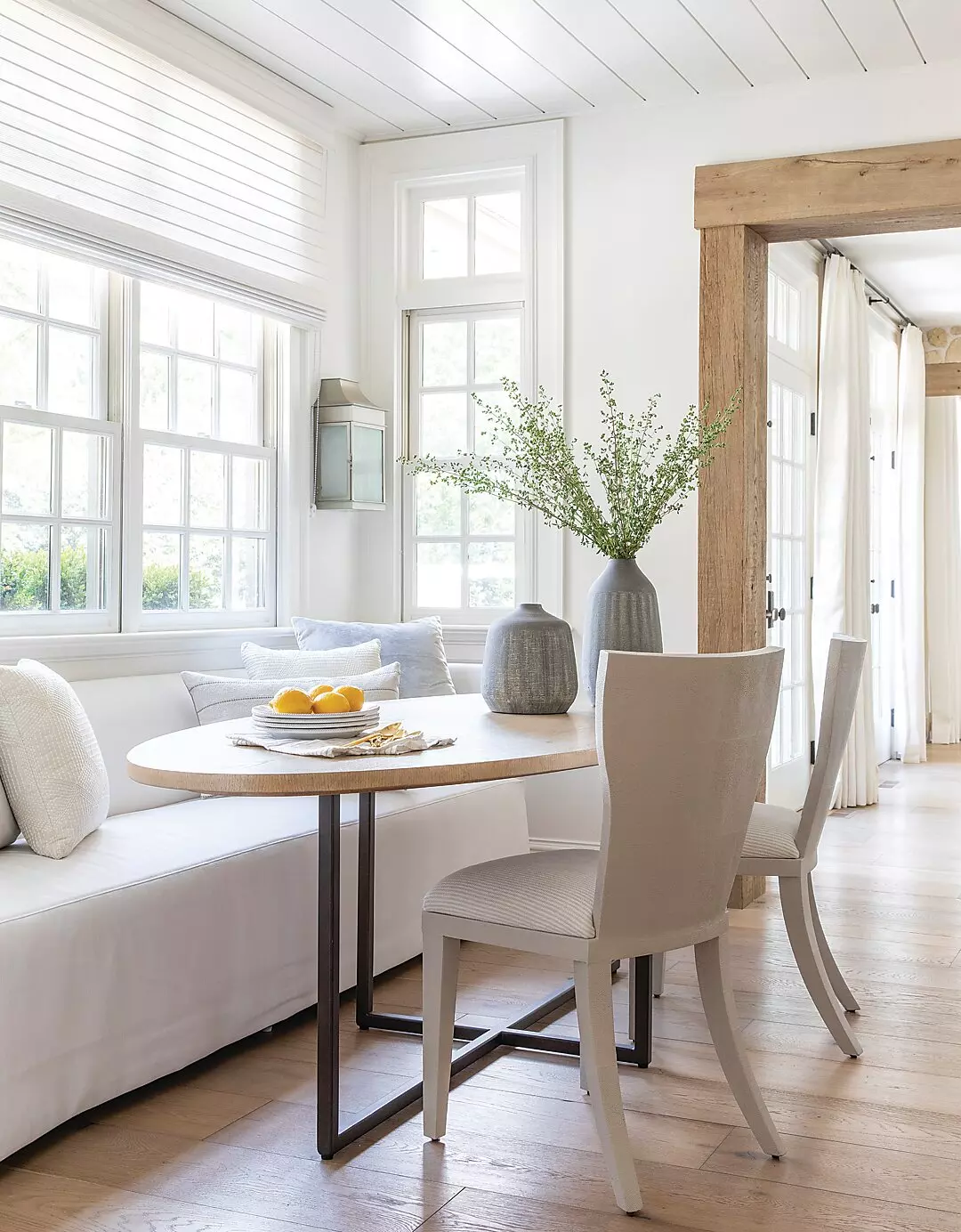 A living room with windows designed by Marie Flanigan